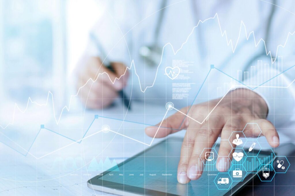 Hand holding a tablet displaying data charts and graphs, representing the critical planning of data management systems in clinical trials to handle large and diverse data sets efficiently.