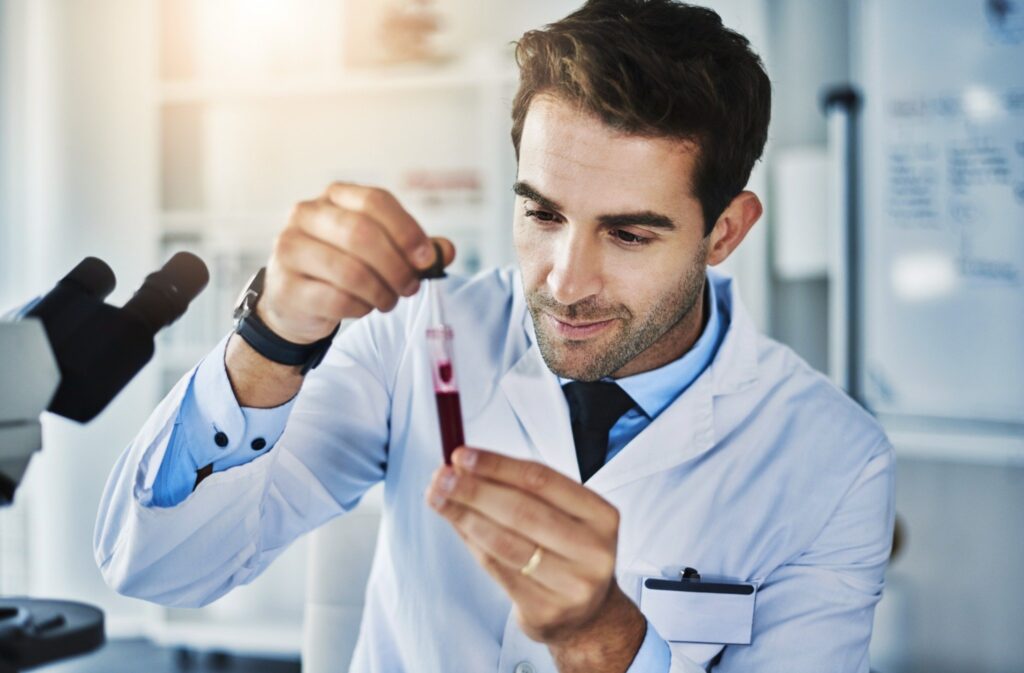 Scientist analyzing a blood sample during early-phase clinical research.