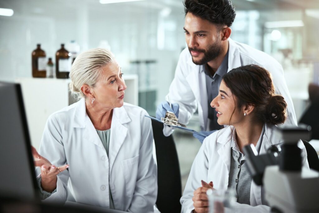 Researchers collaborating and discussing data during large-scale clinical trials