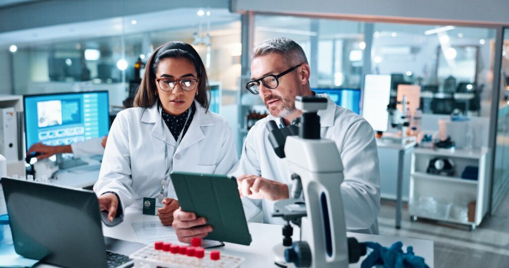 Scientists analyzing data in a laboratory for real-world evidence studies.