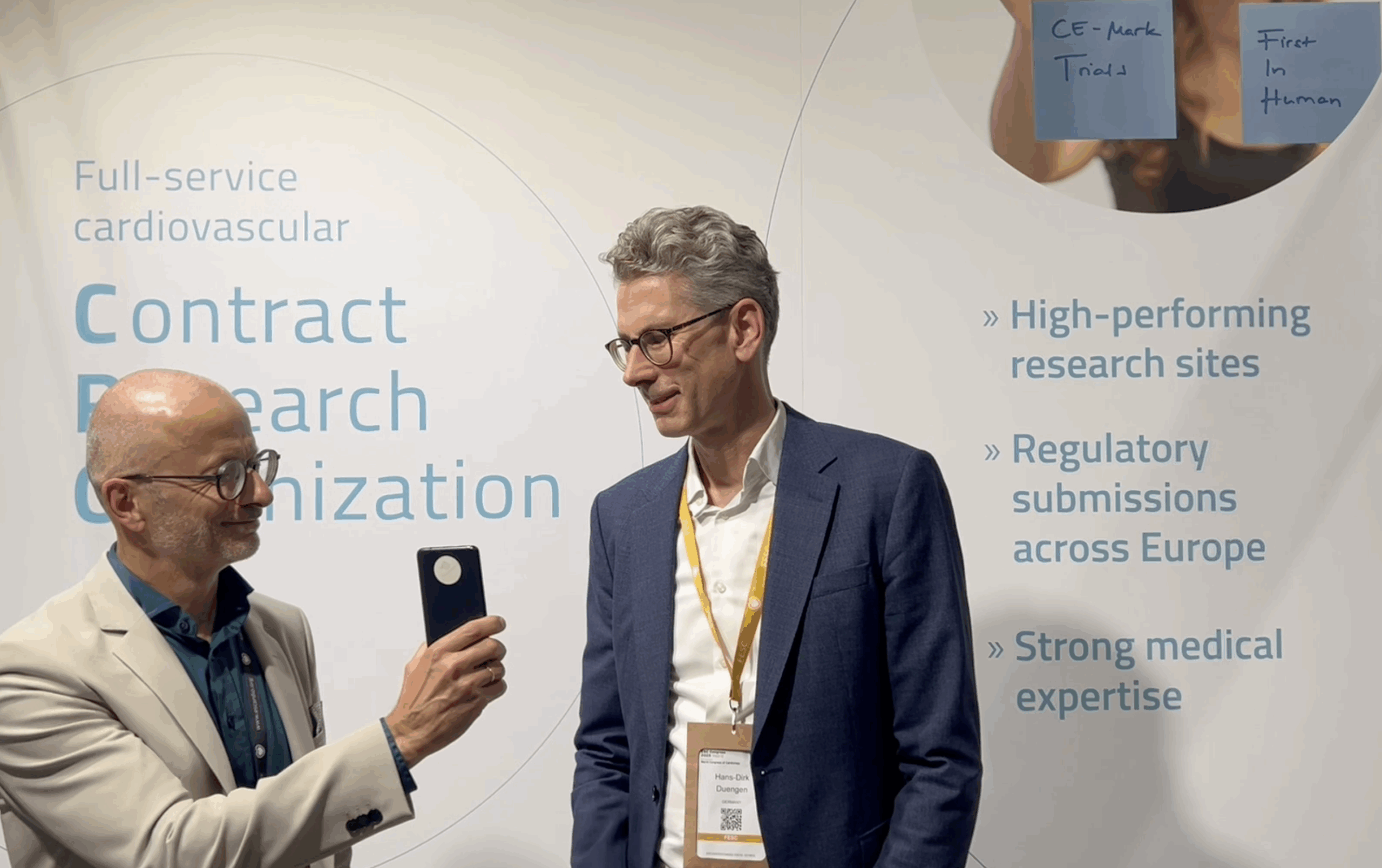 Prof. Dr. Thomas Bernd Dschietzig, CEO of Relaxera, and Prof. Dr. Hans-Dirk Düngen, CEO of SCIRENT, at the SCIRENT booth during ESC 2025 in Madrid. The two experts discuss the SOURCE-HF phase 2 clinical trial investigating relaxin-2 in heart failure.